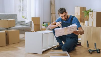 Technician assembling a large wardrobe